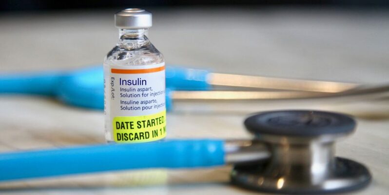 Stethoscope next to insulin medication